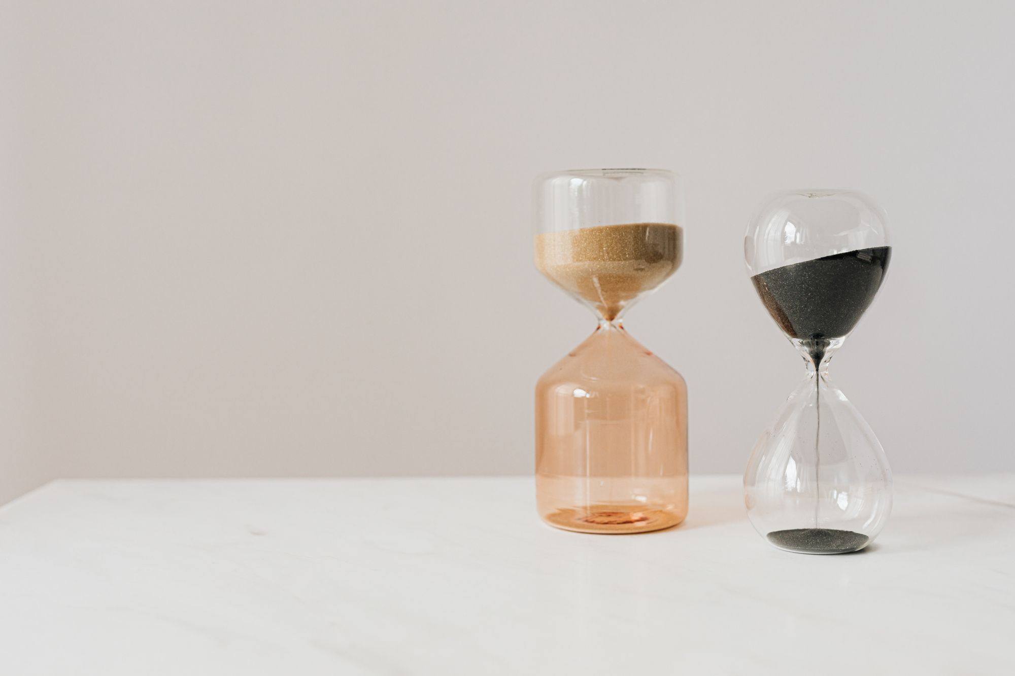 An hourglass with sand running through it, representing time, patience, and the long-term nature of Saturn sign compatibility