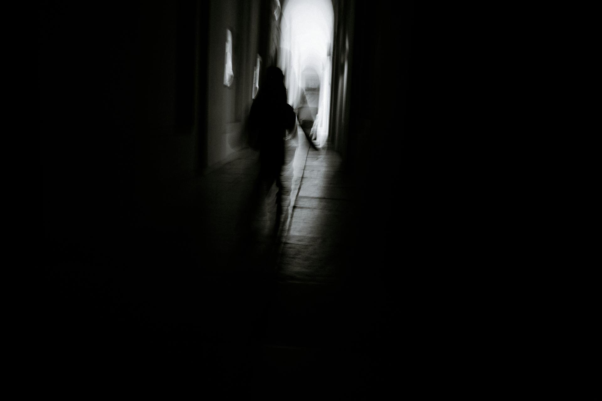 A lone figure in silhouette against a dim sky, representing Scorpio's self-possession and quiet power