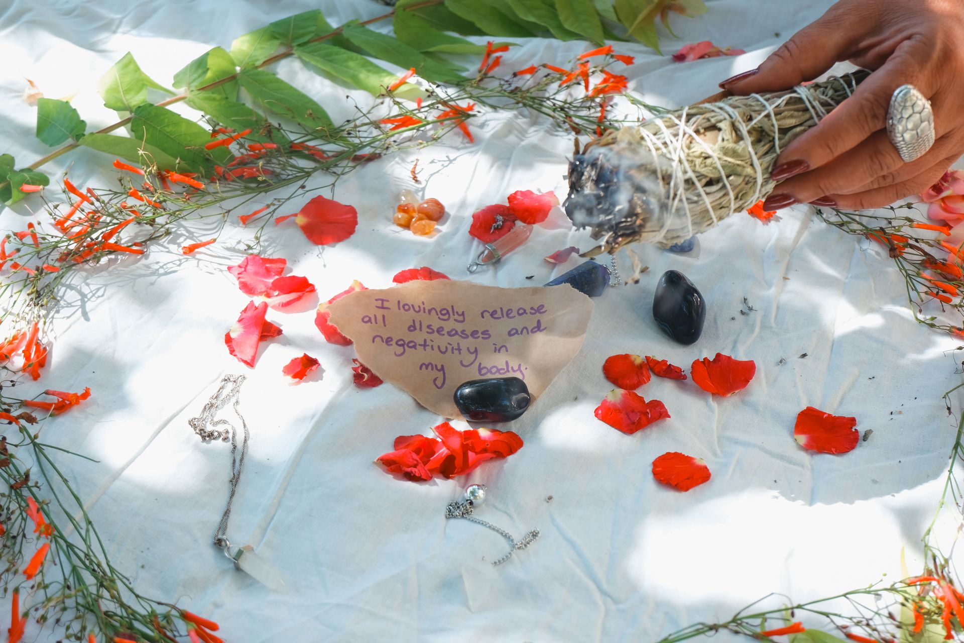 A calm ritual setup with a candle, dried herbs, and soft light for an intentional writing session