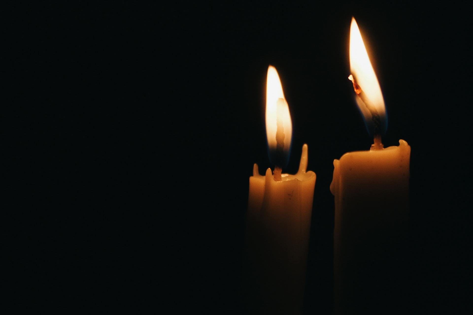 A lit candle flame burning against a dark background, one of the simplest surfaces for fire scrying