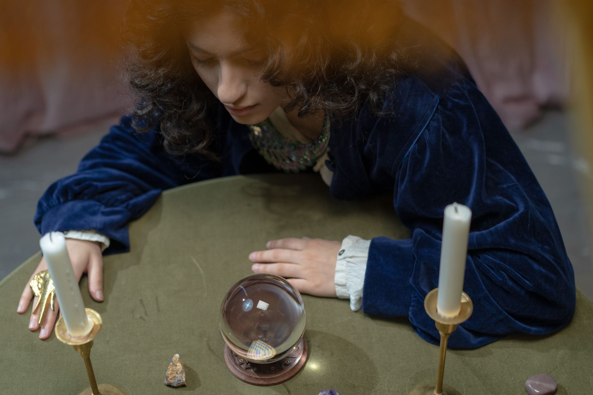 A pair of hands cradling a clear crystal ball, the receptive posture at the center of scrying practice