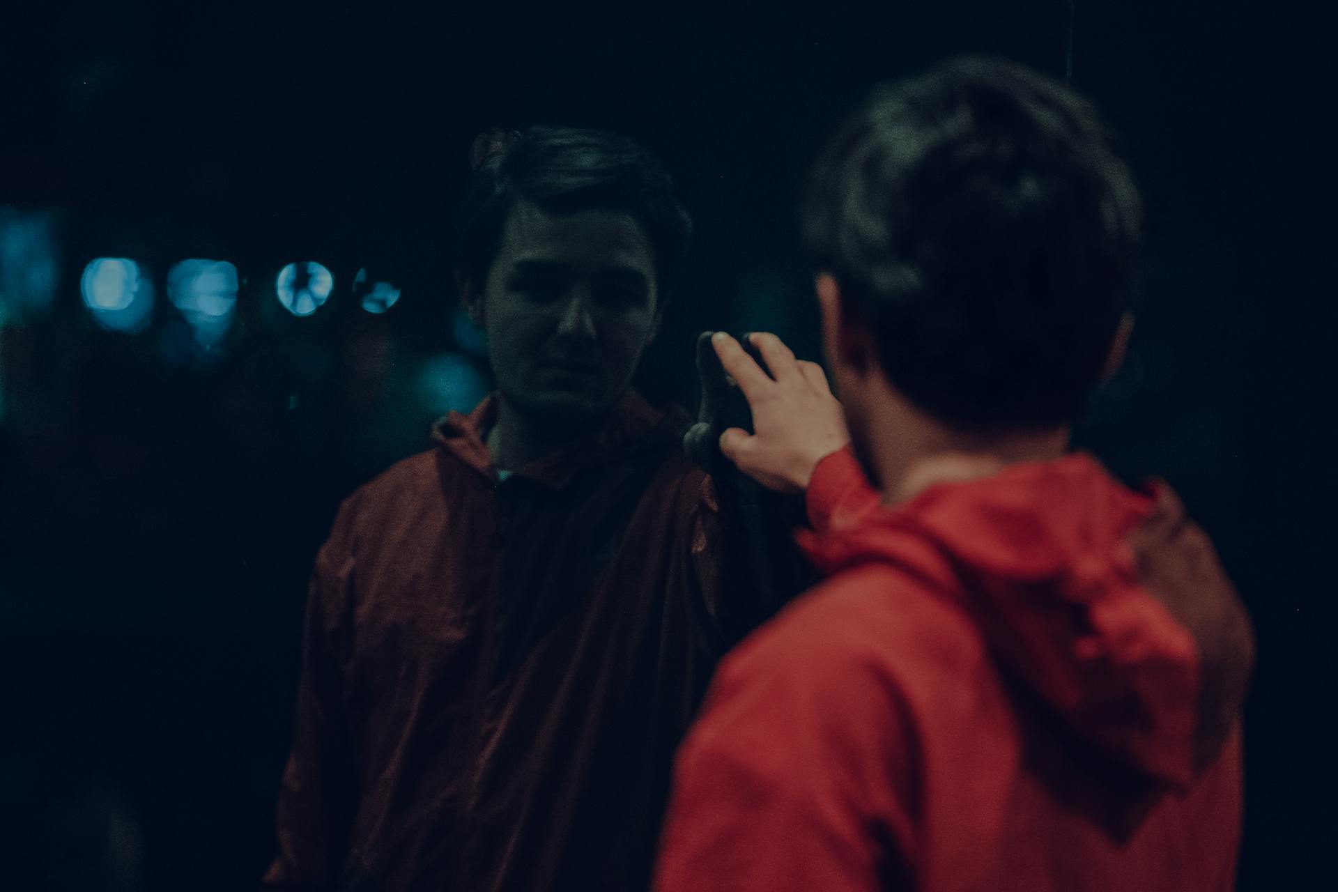 Moody silhouette of a figure reflected in dark water representing the duality of conscious and unconscious self