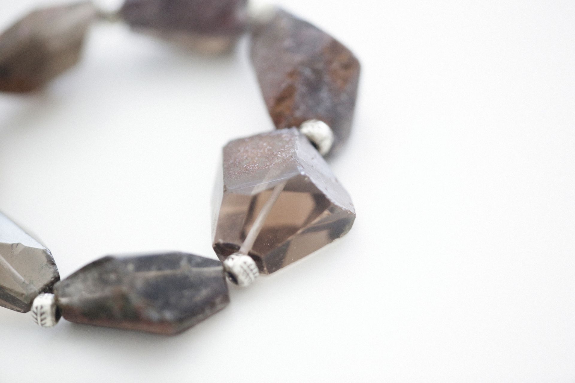 A bracelet of faceted translucent smoky brown quartz beads, one of the most popular ways to wear smoky quartz