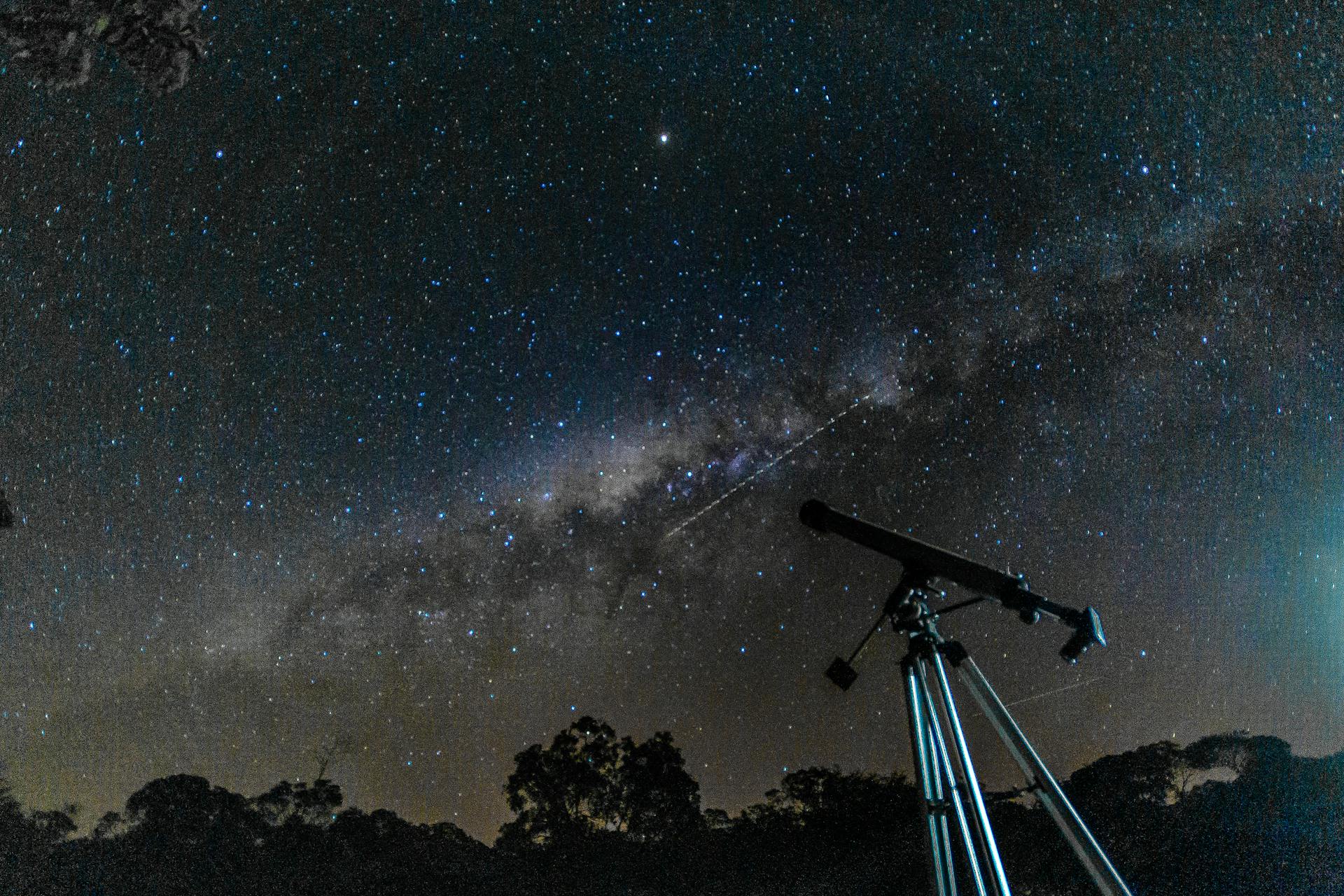 Telescope pointed at the night sky with stars representing the observational precision needed for solar arc direction analysis