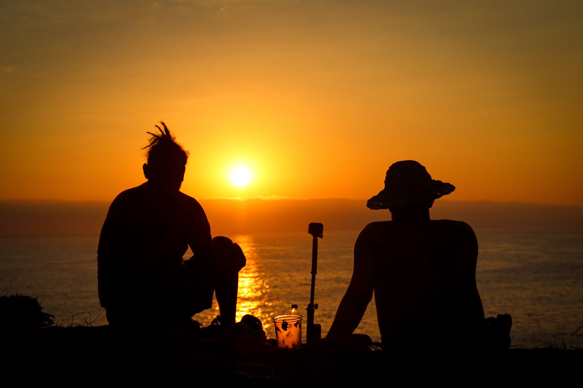 Two people sitting close together at sunset, representing how sun and moon combinations shape relationships