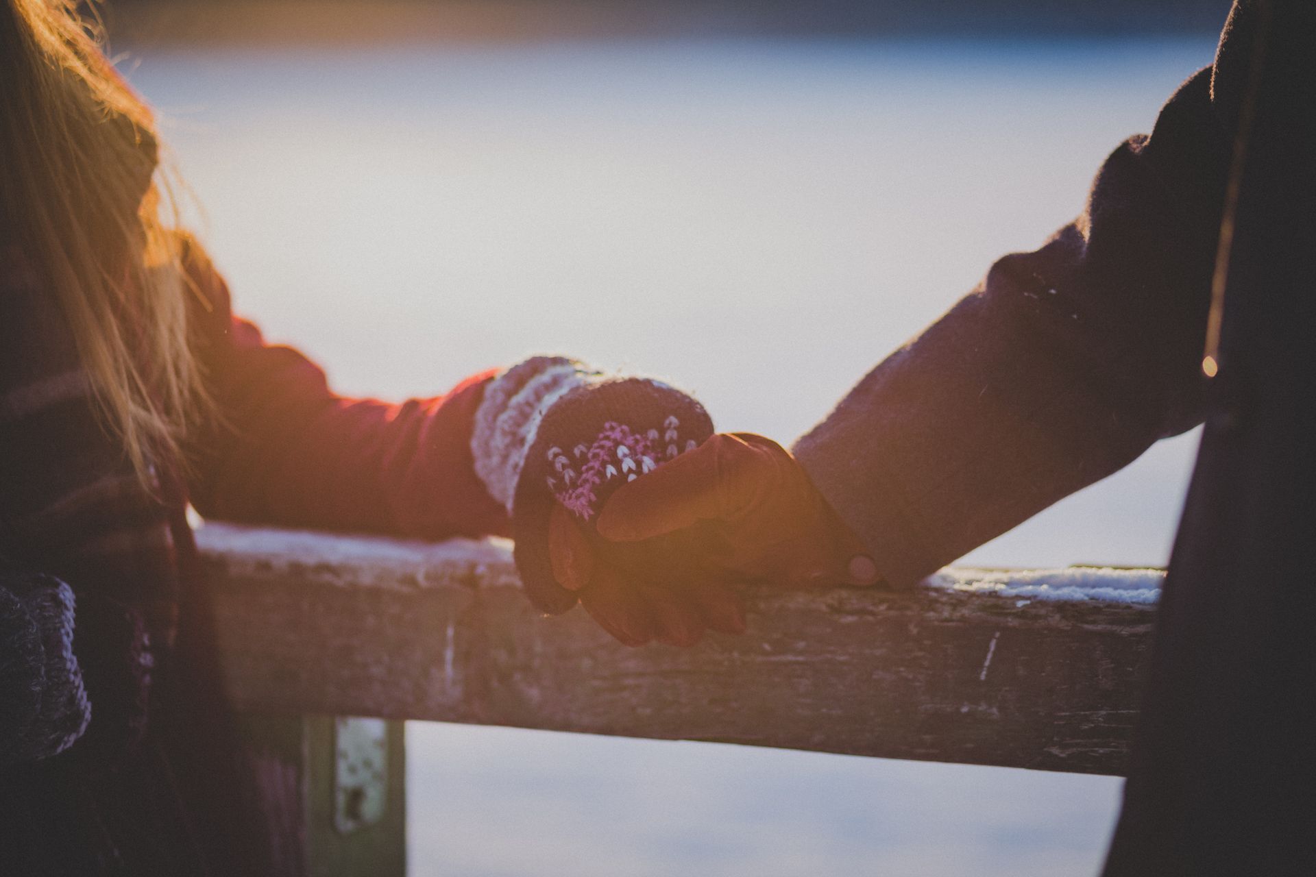 Couple holding hands at sunset, symbolizing the emotional flow of supportive synastry aspects