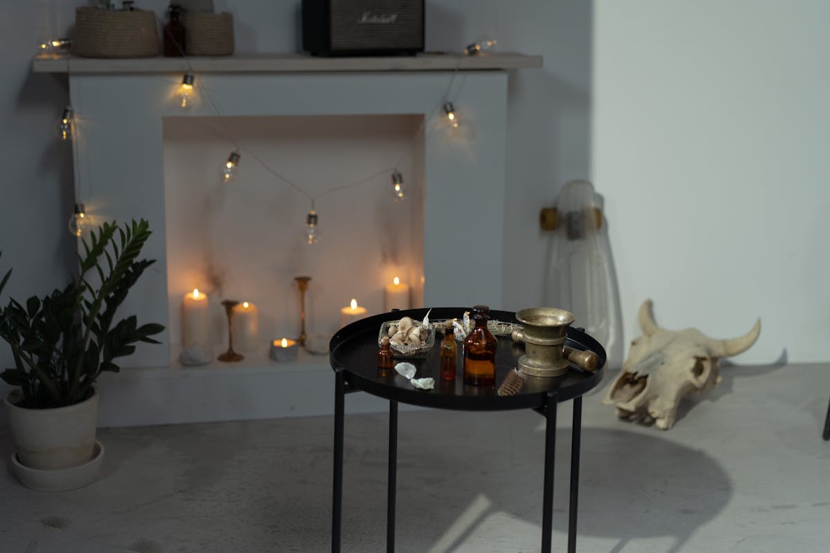 Mystical room with candles, potions, and ritual objects on a table