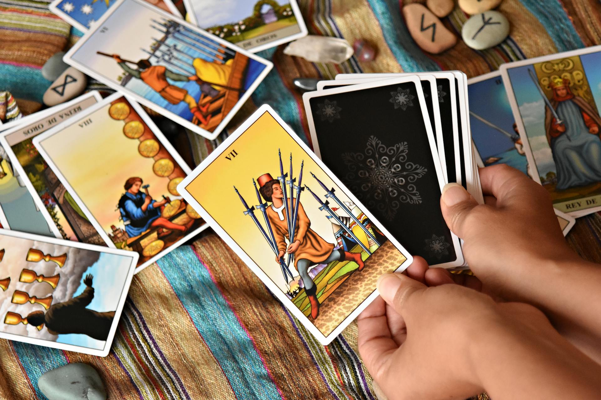 Hands holding tarot cards during a reading session
