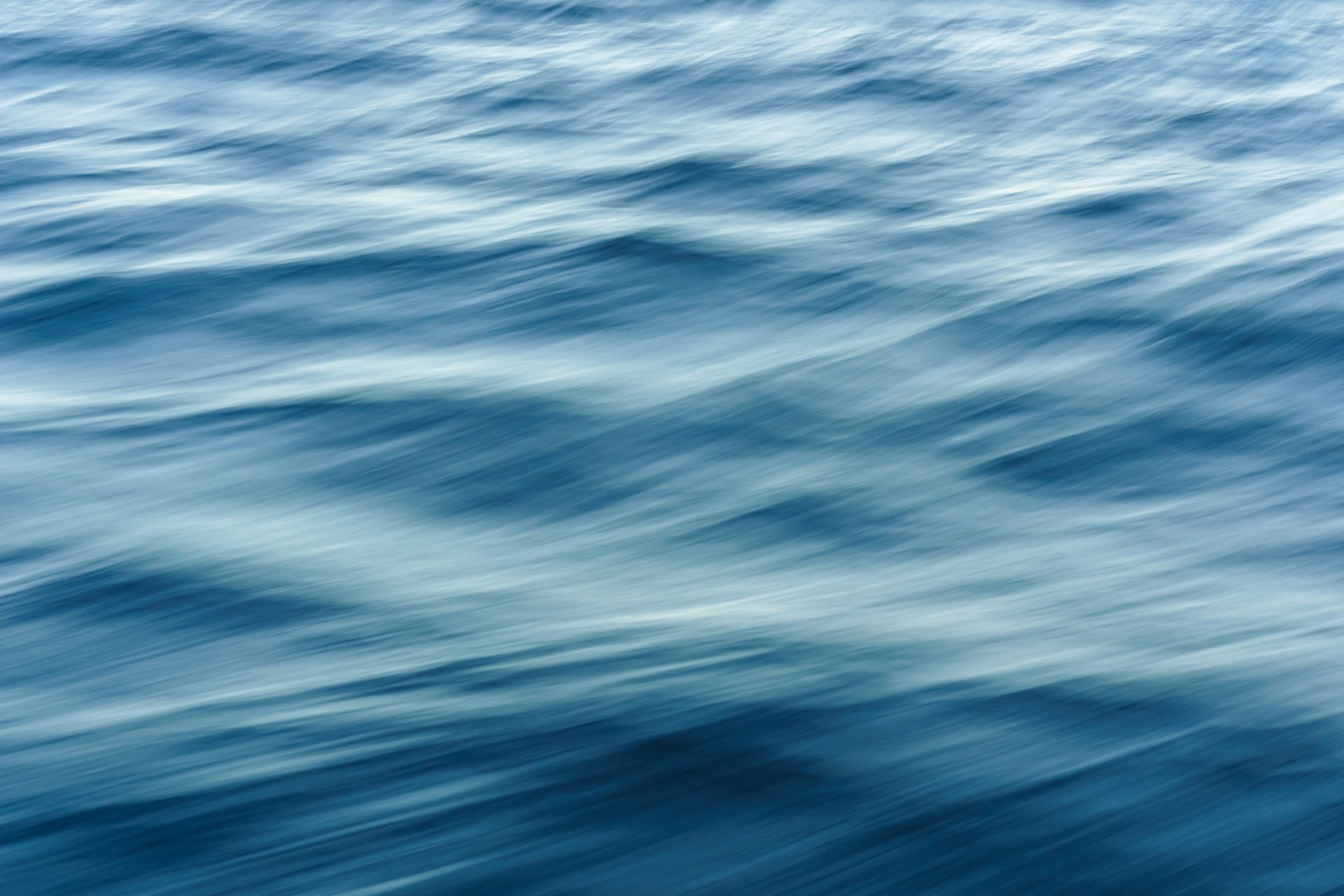 Ocean waves rolling under soft light, symbolizing the water element and emotional depth of the tarot suit of Cups