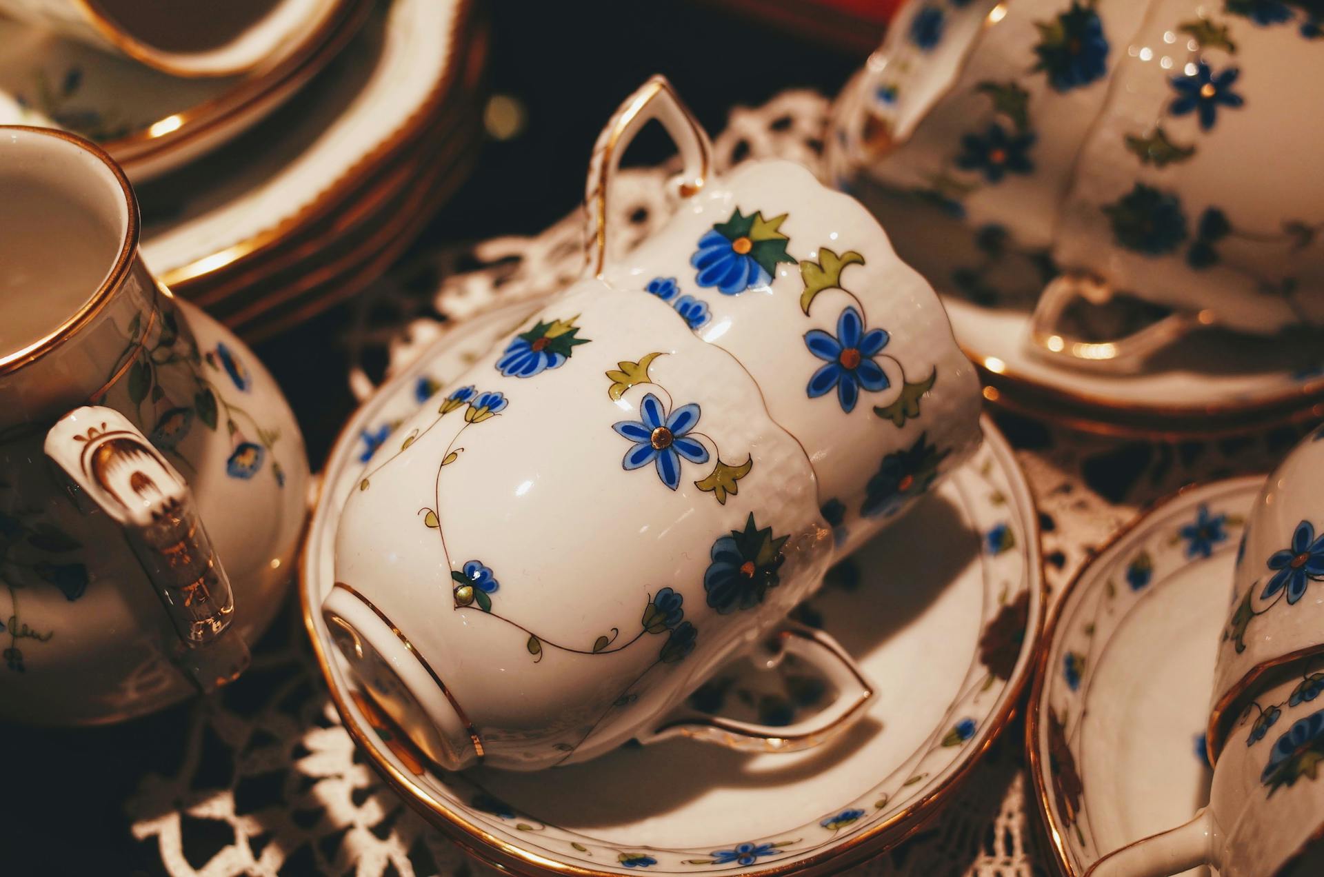 An elegant floral porcelain tea set with gold trim arranged for a tea leaf reading session