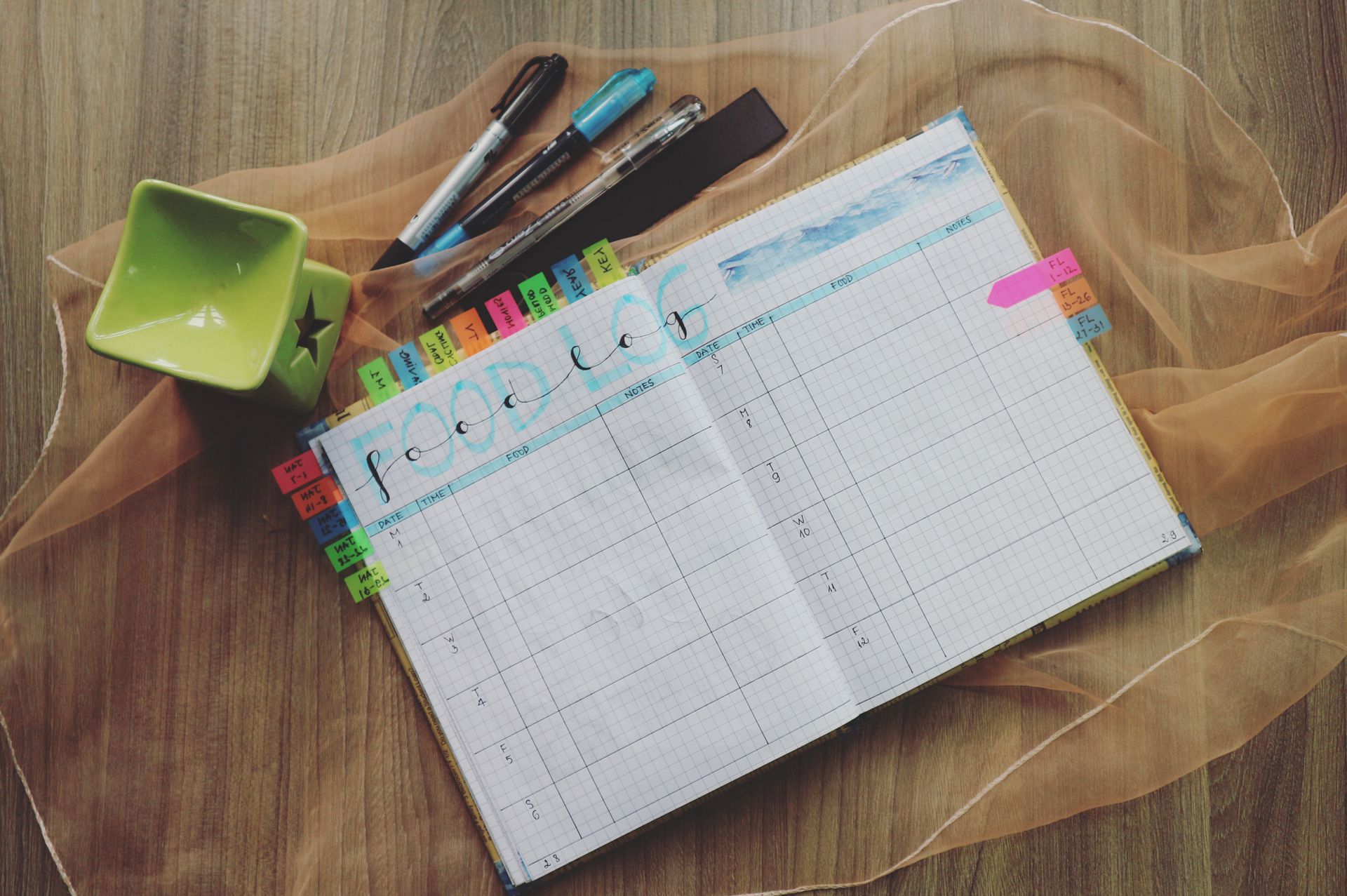A person writing carefully in a planner at an organized desk, capturing Virgo's methodical, analytical, detail-loving mind